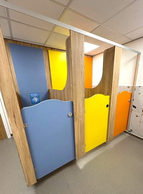 Penguin themed Rainbow printed school cubicles with bright blue doors