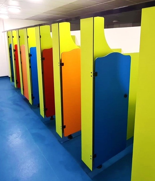 Vibrant Rainbow primary school toilet cubicles with bright colour panels
